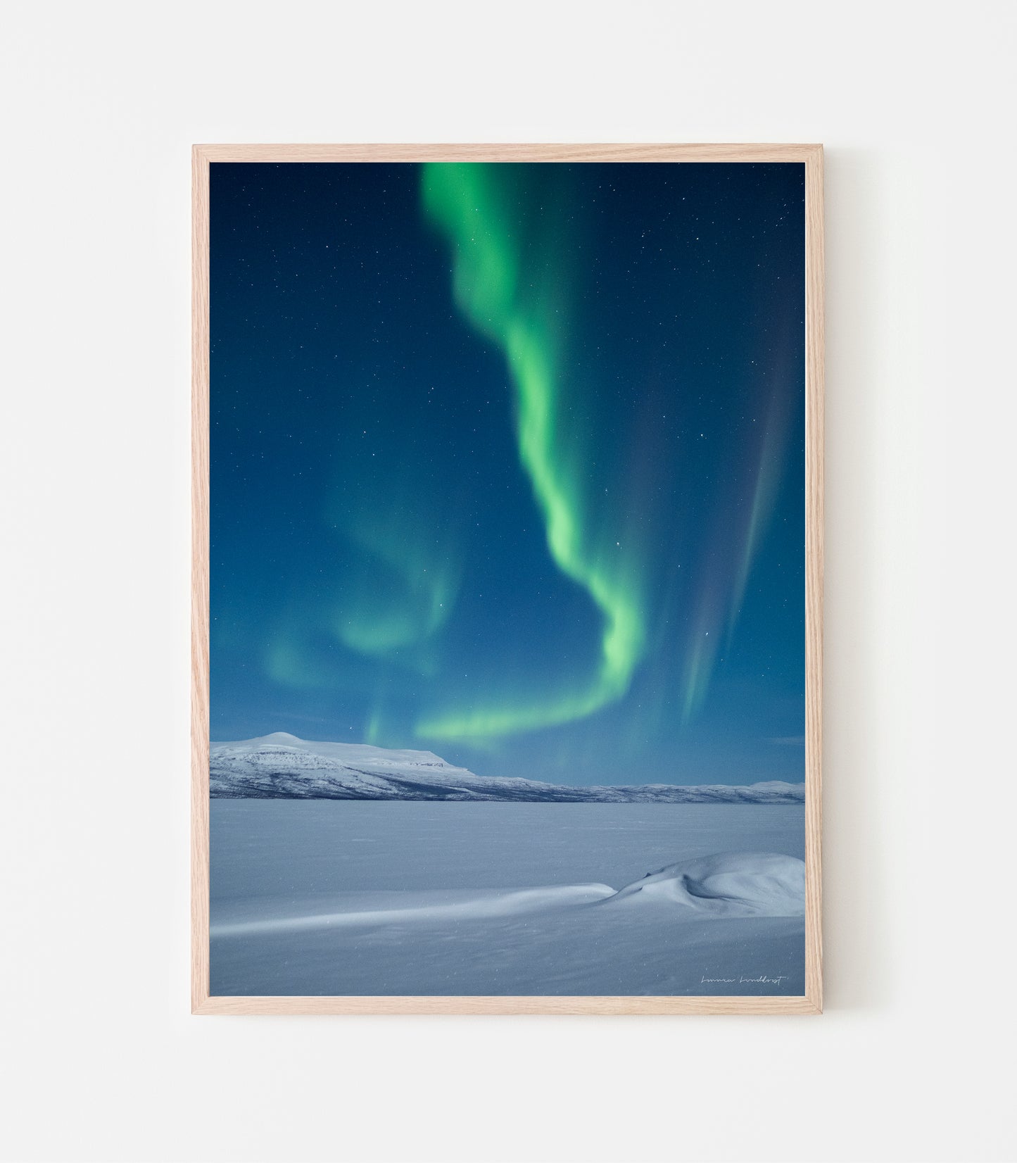 Det var starkt månsken och norrsken vid Torneträsk när jag tog den här bilden. Norrsken vid Torneträsk, print av fotograf Linnea Lundkvist.